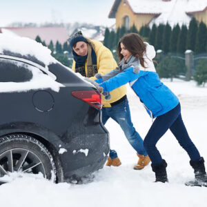 Couple Pushing Car stucked in Snow