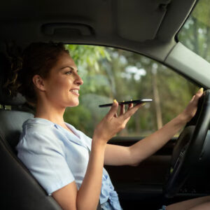 Woman using voice command while driving car.