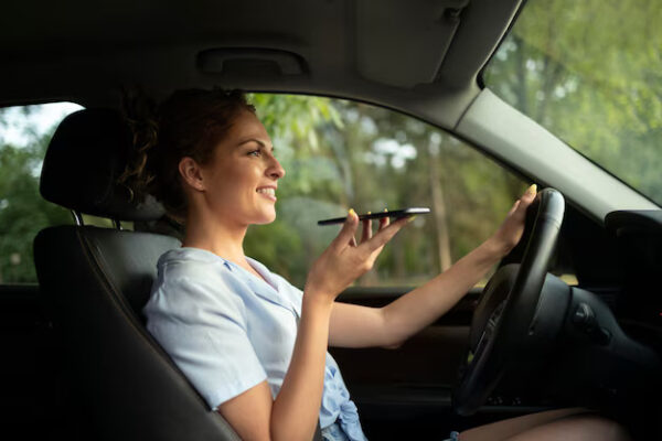 Woman using voice command while driving car.