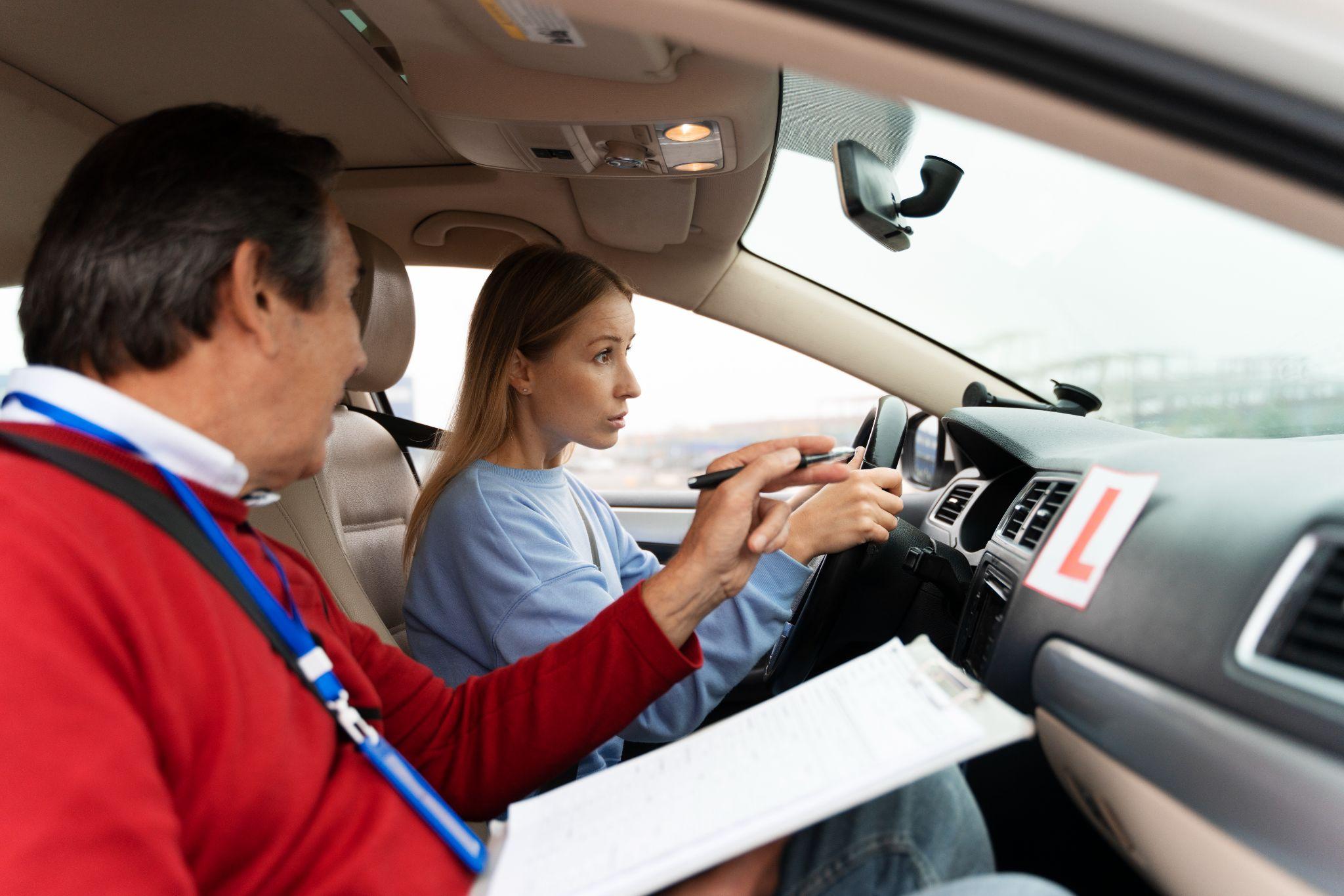 Man Teaching learner about driving rules