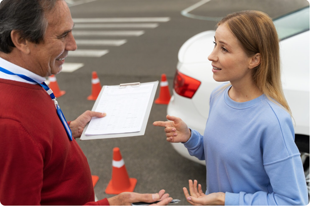 Driving instructor with student next to car
